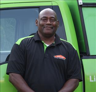 Photo of Lloyd in front of decaled SERVPRO Service Van