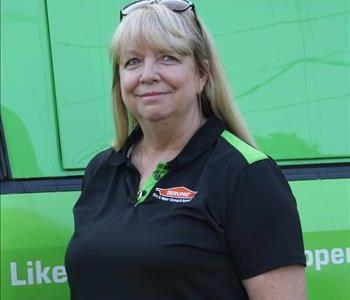 Photo of Joan in front of decaled SERVPRO Service Van