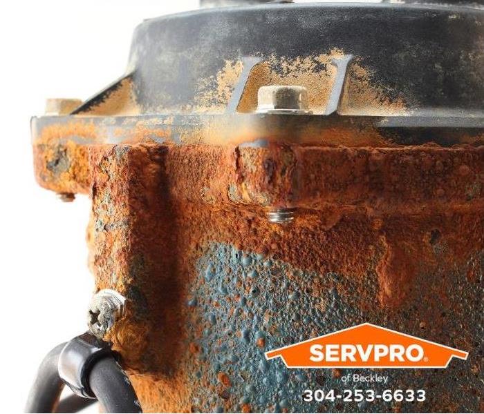 An old, corroded sump pump is shown.