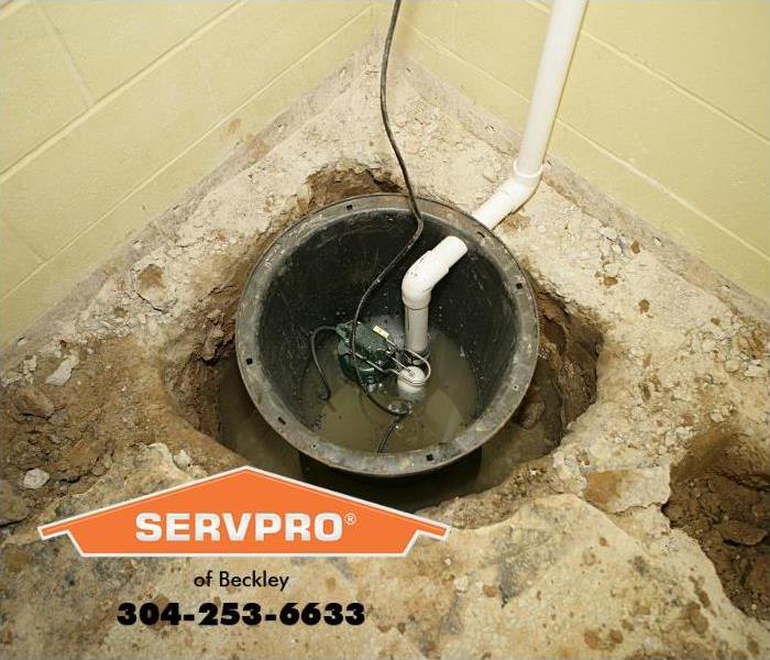 A sump pump is shown installed in a basement. 