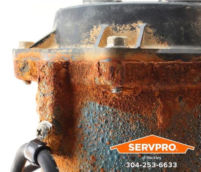 An old, corroded sump pump is shown.