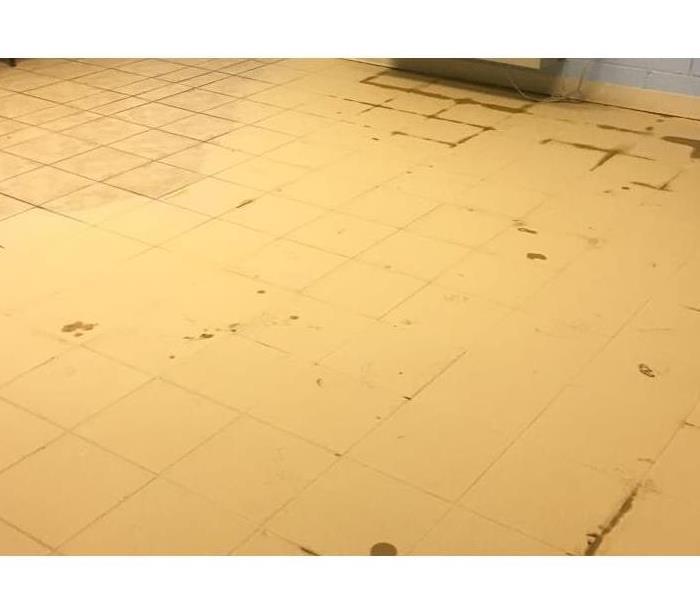 Tile flooring covered in yellow mud