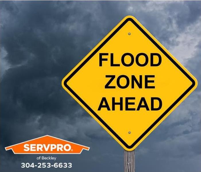 A sign reads, “Flood Zone Ahead.”