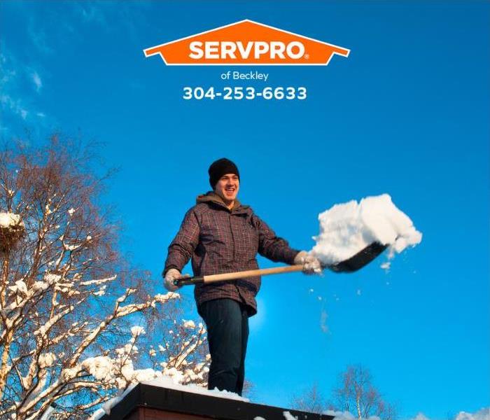 A person removes snow from their roof.